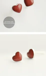Close-up of red heart studs in 925 sterling silver with a polished platinum finish