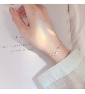 Detailed view of S925 sterling silver ginkgo leaf bracelet with elegant prism light effects