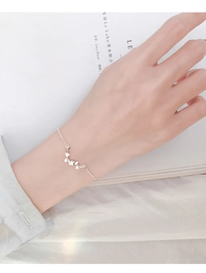 Detail of S925 sterling silver ginkgo leaf bracelet worn on a woman's wrist