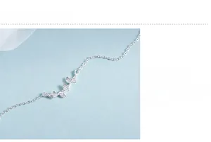 Macro detail of S925 sterling silver ginkgo leaf pendant with polished cross chain link
