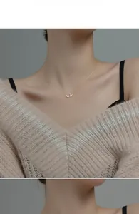 Close-up of elegant gold butterfly pendant necklace with zircon stones on model