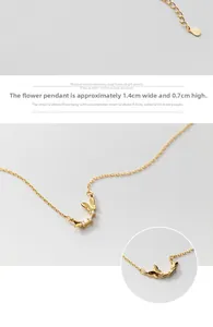 Close-up of golden butterfly pendant with white crystals and adjustable link chain details
