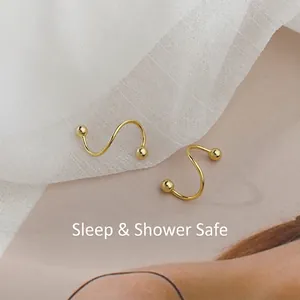 Minimalist S-shaped spiral earrings in golden finish with dual metal beads design