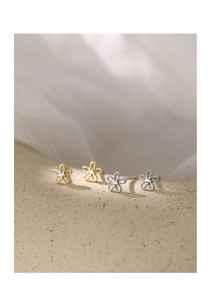 Macro detail of 925 sterling silver flower earrings with zircon in gold and silver plating