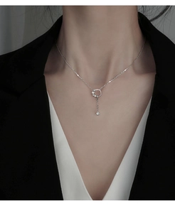 Detailed view of silver circle fringe necklace with sparkling cubic zirconia on a model