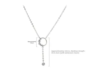 Detail of silver tassel necklace showing zirconia paved circle pendant and extender chain