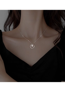 Detail of silver circle pendant with pearl on a minimalist choker necklace for women
