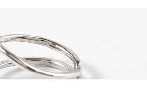 Macro shot of S925 sterling silver stamp on minimalist crisscross open ring band