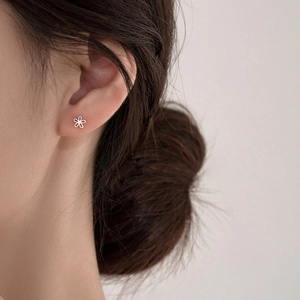 S925 sterling silver flower stud earrings with zircon stone on model's ear