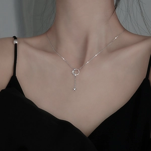 Elegant silver tassel moon necklace with sparkling crystals shown on a model