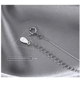 Macro shot of S925 sterling silver spring clasp and extension chain with hallmarks