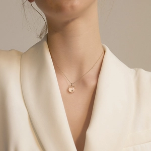 Elegant S925 silver necklace with pink apple pendant and gold bow on female model
