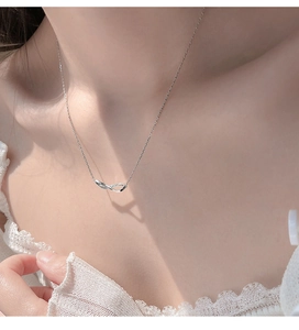 Close-up of infinity pendant necklace with sparkling crystals worn on the neck