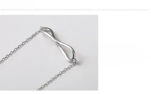Macro detail of S925 sterling silver infinity pendant with white zircon stones