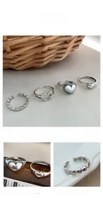Detailed macro view of S925 sterling silver heart rings with retro woven textures