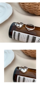 Detailed macro of vintage silver heart rings with adjustable open band for women