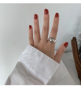 Detail of vintage silver heart ring with beaded edges worn on finger for a stylish look