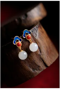 Detailed macro view of 925 silver Hetian jade earrings with blue enamel cloud pattern