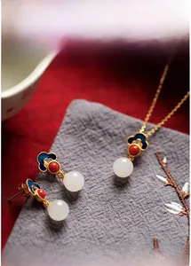 Detailed view of 925 silver Hetian jade earrings with blue enamel ruyi cloud patterns