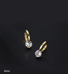 Macro shot of 925 sterling silver gold plated hoop earrings with clear crystal stones