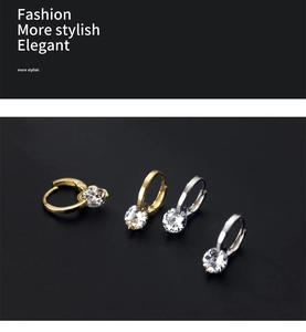 Detail view of gold and silver leverback hoop earrings with large round zircon stones