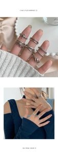 Detalle de anillos plateados vintage con texturas de cadena y diseño de nudos