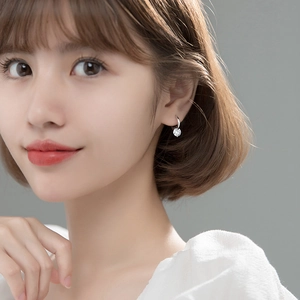 Elegant sterling silver hoop earrings featuring a sparkling round cubic zirconia drop charm