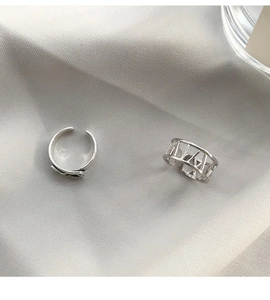 Detail of silver adjustable open rings with minimalist band and Roman numeral cutout design