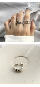 Detail of belt buckle design ring and Roman numeral cutout ring in silver finish