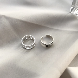 Set of two S925 sterling silver rings with Roman numeral cutout and smiley face design