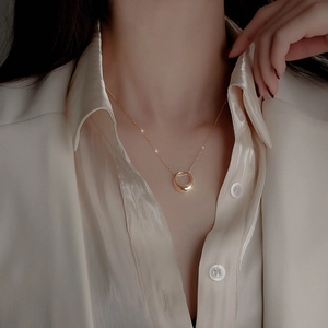 Minimalist gold circle necklace on model, elegant geometric choker for women style