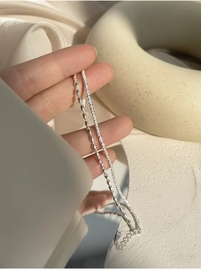 Macro view of double-layer S925 sterling silver bracelets with melon seed and star links