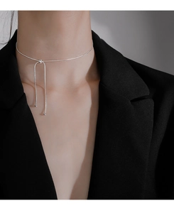Detail of adjustable silver snake chain choker necklace on model wearing black suit