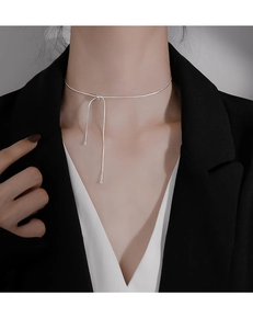 Silver snake chain choker necklace with adjustable sliding knot on a female model