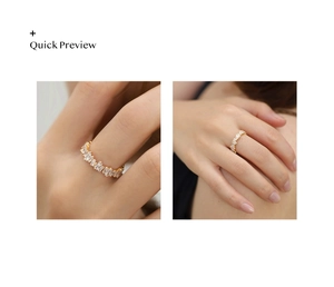 Close-up of golden ring with channel-set baguette cut crystals on a model's hand