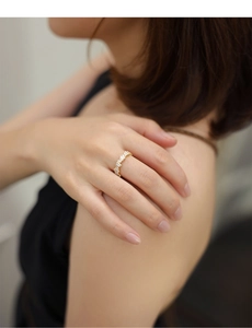 Detail of baguette-cut zircon stones inlaid on a luxury golden sterling silver ring
