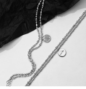 Double-layer silver necklace featuring Lucky engraved charm and matte round pendant