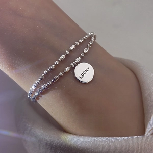 Sparkling double-layered silver bead bracelet featuring a Lucky engraved round pendant