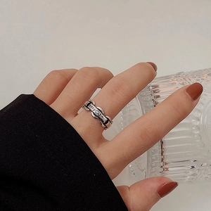 Retro silver chain ring with keep smile engraved plaque on a textured glass
