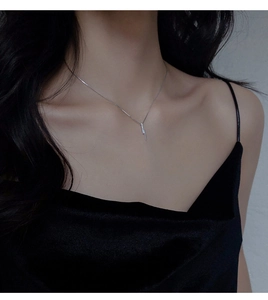 Macro shot of S925 silver vertical bar pendant necklace with sparkling micro-inlaid stones