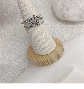 Macro shot of vintage silver ring with Love Me engraving and multilayer clover design