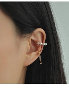 Detailed close-up of vintage pearl tassel ear cuff with elegant gold chain for women