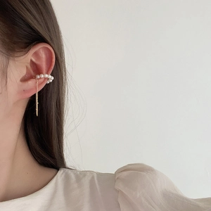 Vintage pearl ear cuff with long gold tassel fringe for non-pierced ears in warm aesthetic