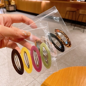 Set of six colorful acetate oval hair clips featuring marble and tortoiseshell patterns