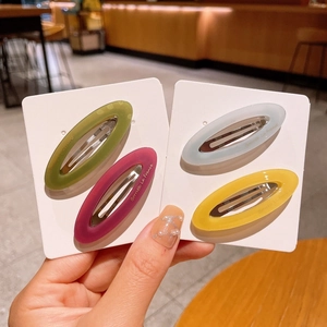 Detailed set of 4 matte oval acetate hair clips in green, rose, blue, and yellow
