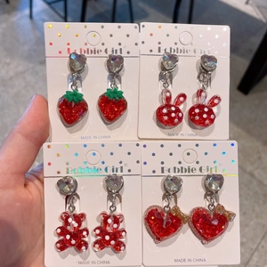 Set of four red glitter resin ear clips for kids featuring strawberry and bear shapes