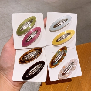 Set of eight hollow oval acetate hair clips in assorted colors and vintage marble patterns