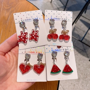 Detailed view of resin cartoon fruit clip-on earrings for girls on display cards