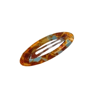 French vintage oval acetate hair clip with amber tortoiseshell pattern and gold label