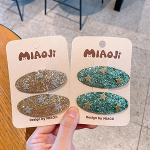 Sparkly star sequin hair clips for little girls in gold and dark green colors
